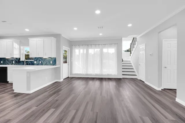 a kitchen with stainless steel appliances granite countertop a stove and a refrigerator