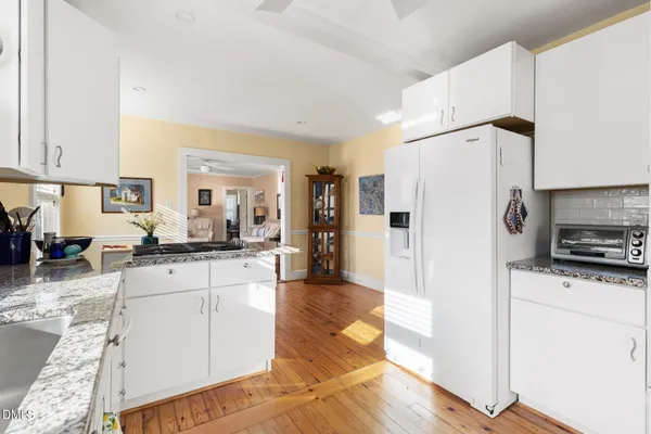 a large white kitchen with a window
