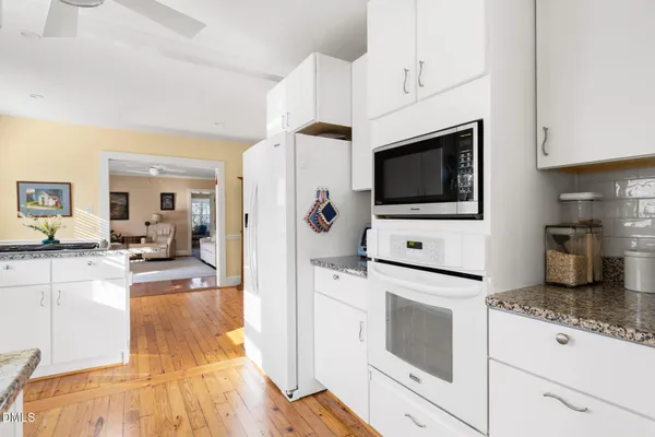 a kitchen with stainless steel appliances a refrigerator sink and cabinets