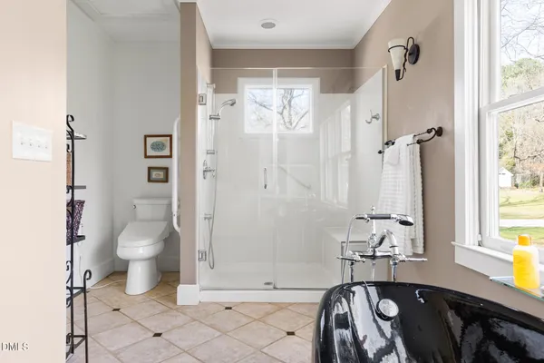 a bathroom with a granite countertop sink a toilet and shower