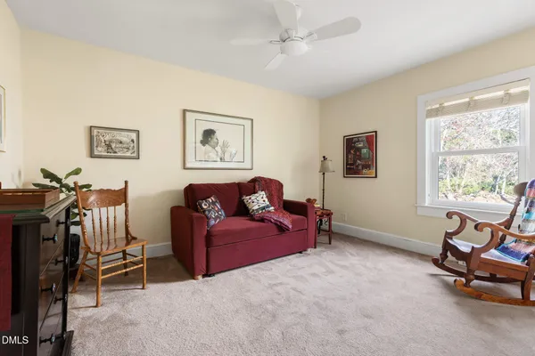 a living room with furniture a air conditioner vent and a window