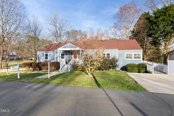 a patio with a table and chairs under an umbrella