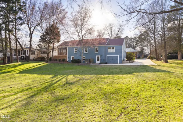 a front view of a house with a yard and fountain