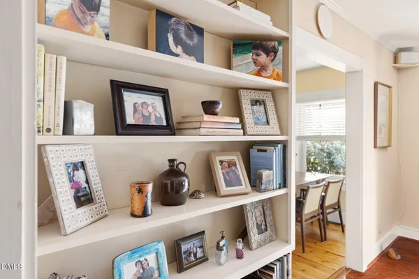 a living room with furniture and a book shelf