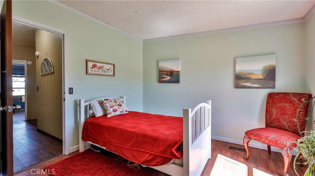 39550 Kirby Road Anza, CA 92539 - Photo 32 of 53 a bedroom with a bed and wooden floor
