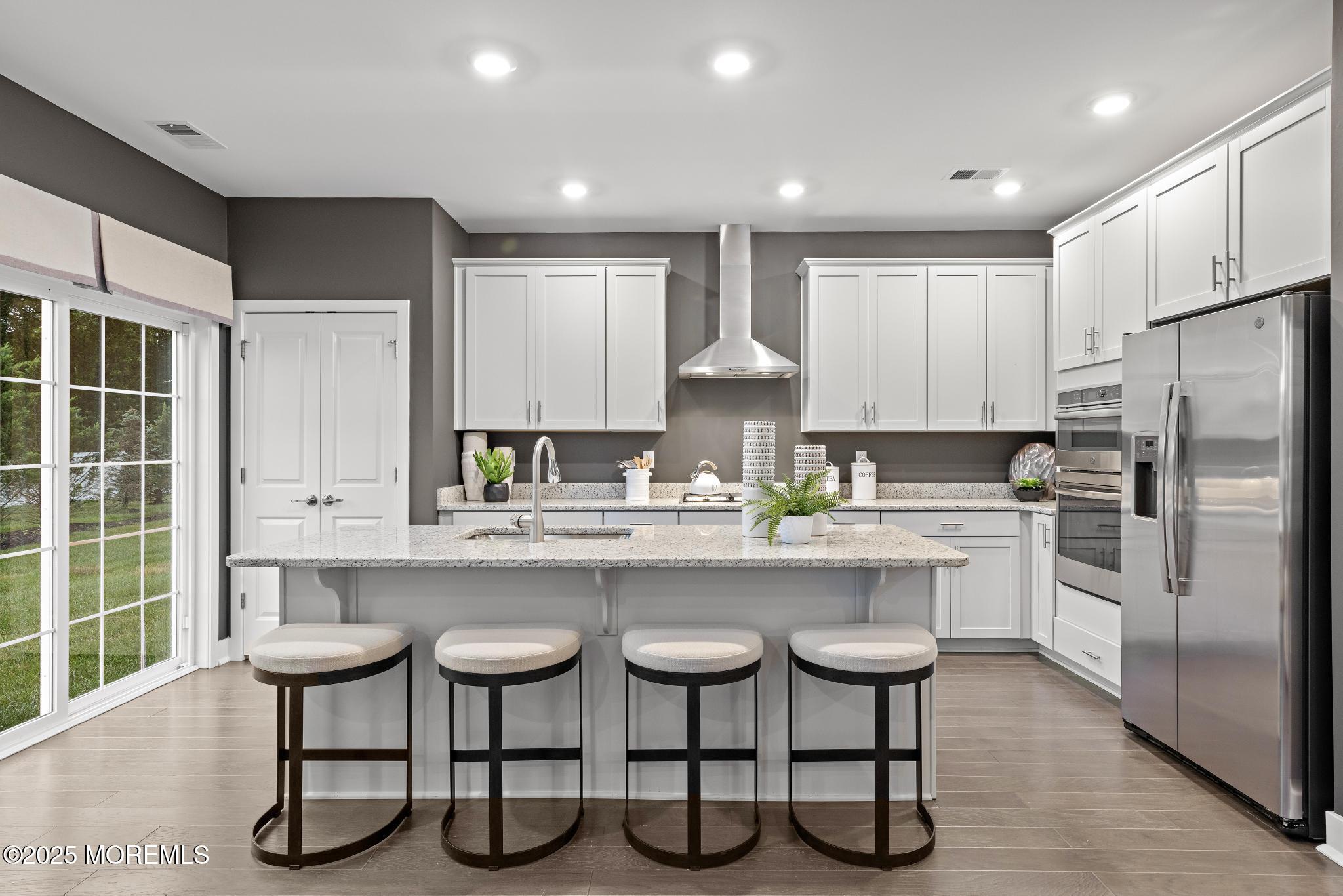 1 Canterbury Road New Egypt, NJ 08533 - Photo 13 of 40 a kitchen with stainless steel appliances a table chairs refrigerator and microwave