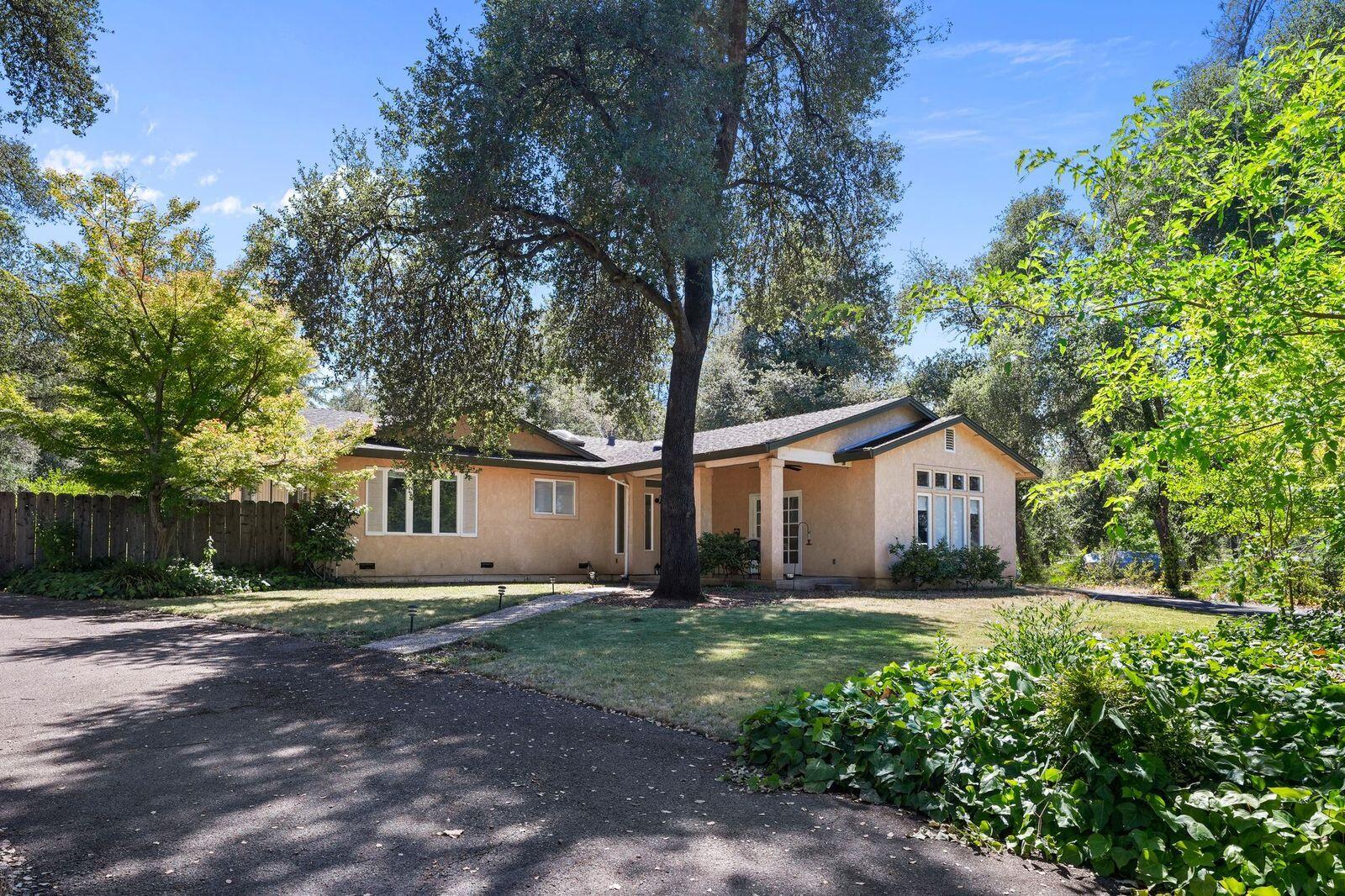 8710 Redbank Road Redding, CA 96001 - Photo 1 of 27 a white house that has a tree in front of it
