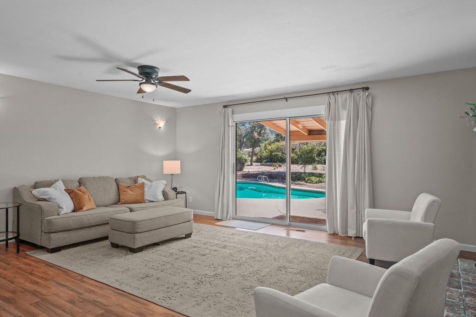8710 Redbank Road Redding, CA 96001 - Photo 10 of 27 a living room with furniture and a large window