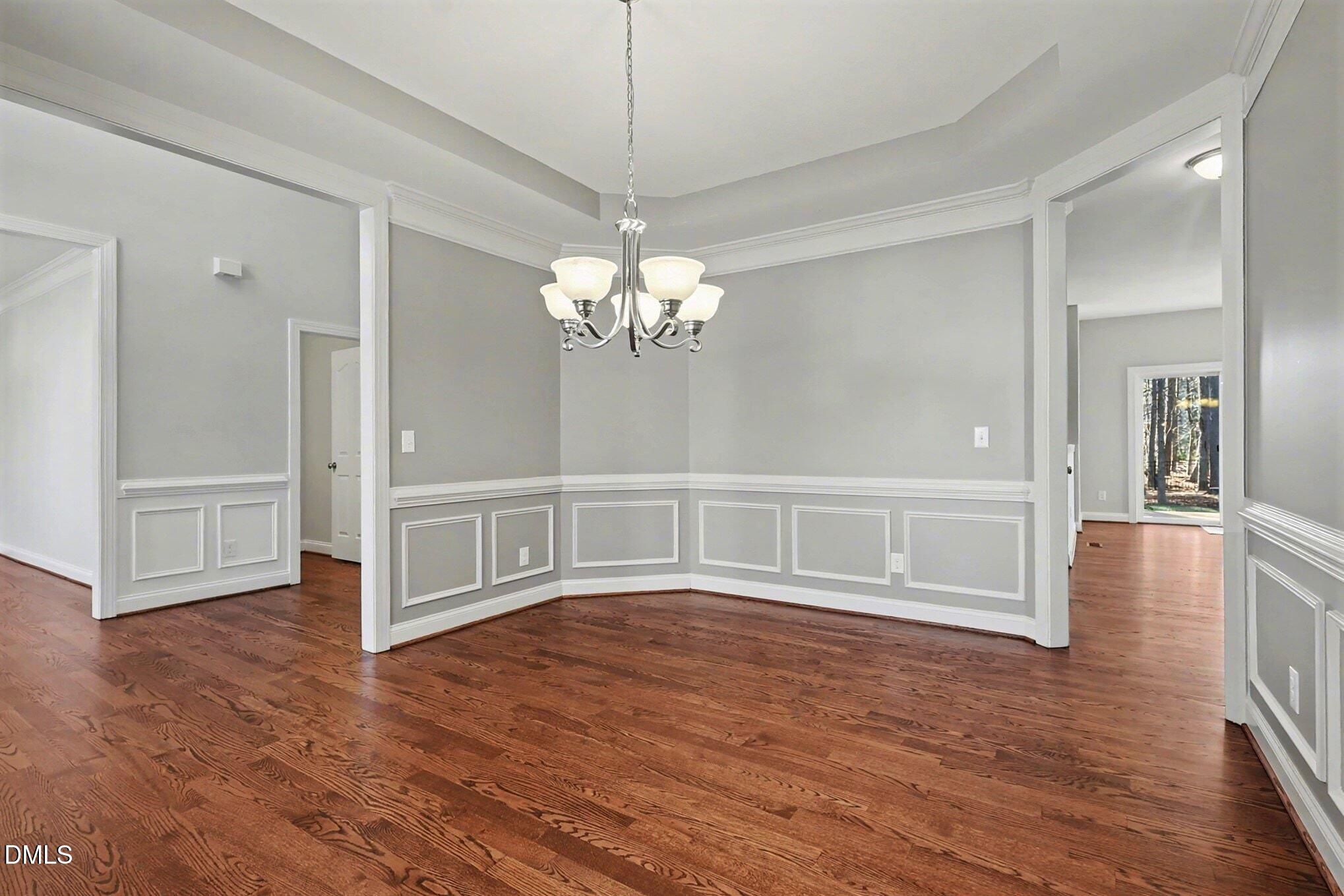 3213 Lebrun Path Fuquay-Varina, NC 27526 - Photo 20 of 58 a view of a livingroom with wooden floor and a kitchen space