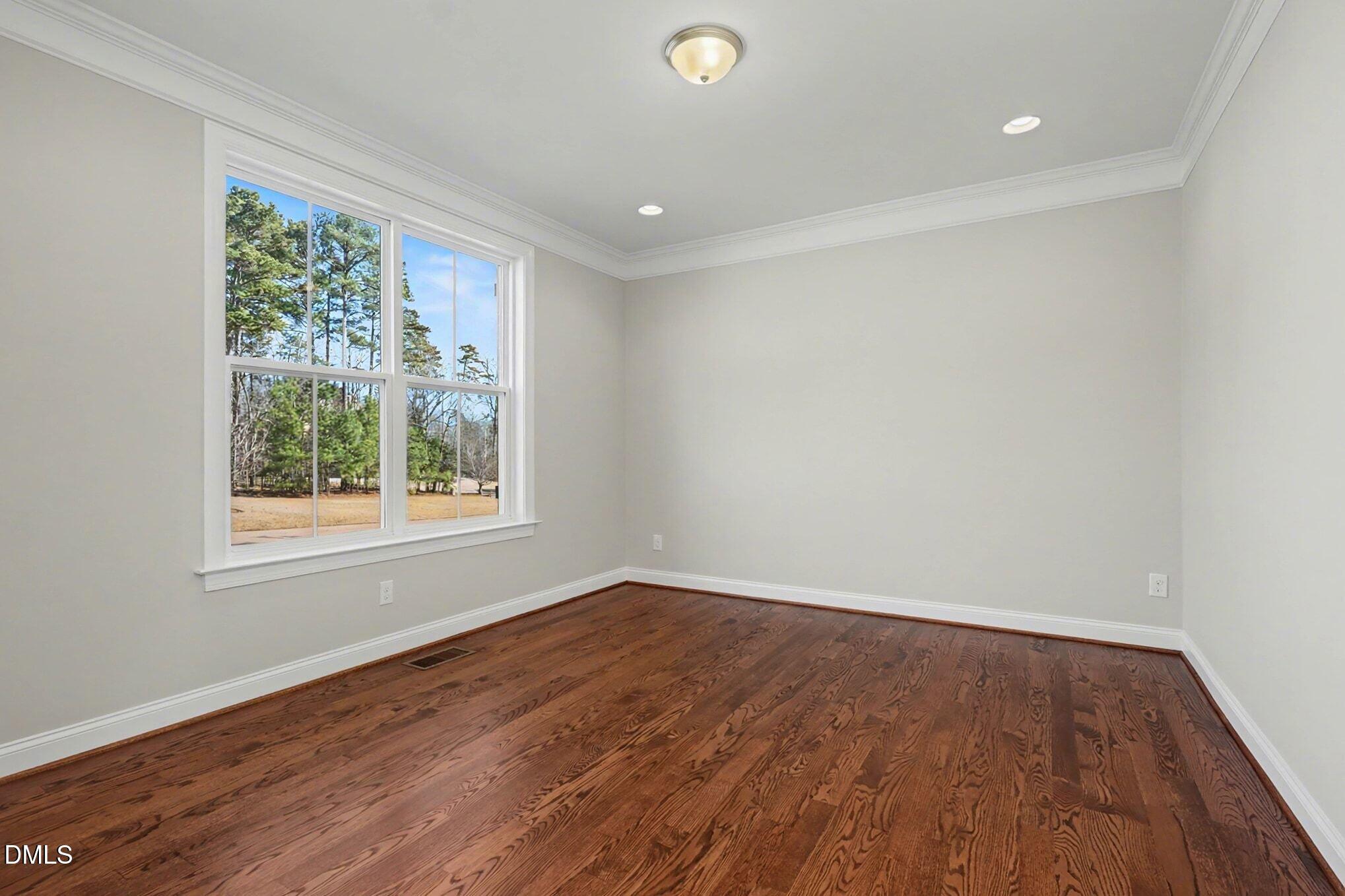 3213 Lebrun Path Fuquay-Varina, NC 27526 - Photo 24 of 58 an empty room with wooden floor and windows