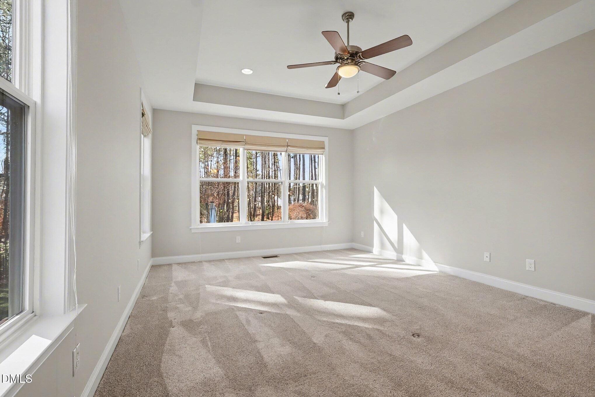 3213 Lebrun Path Fuquay-Varina, NC 27526 - Photo 32 of 58 an empty room with window and ceiling fan