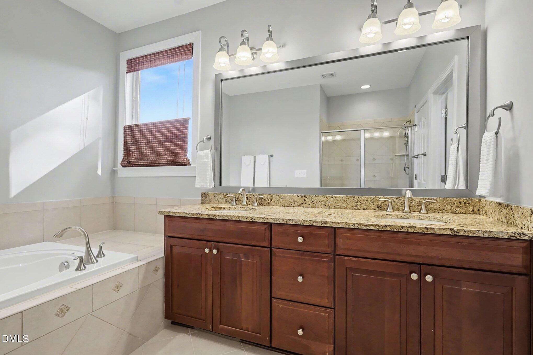 3213 Lebrun Path Fuquay-Varina, NC 27526 - Photo 35 of 58 a bathroom with a granite countertop sink double and mirror