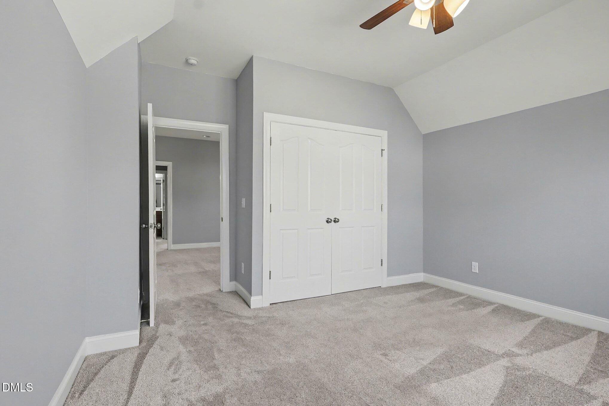 3213 Lebrun Path Fuquay-Varina, NC 27526 - Photo 41 of 58 an empty room with closet and chandelier fan