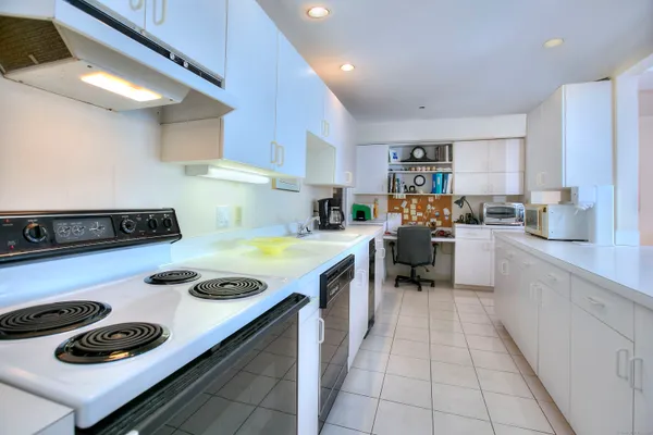 a kitchen with a stove a sink and a refrigerator