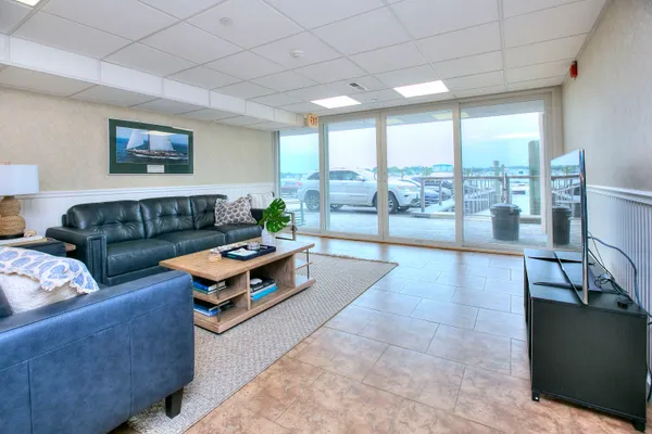 a living room with furniture and a floor to ceiling window
