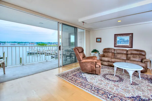 a living room with furniture and a floor to ceiling window
