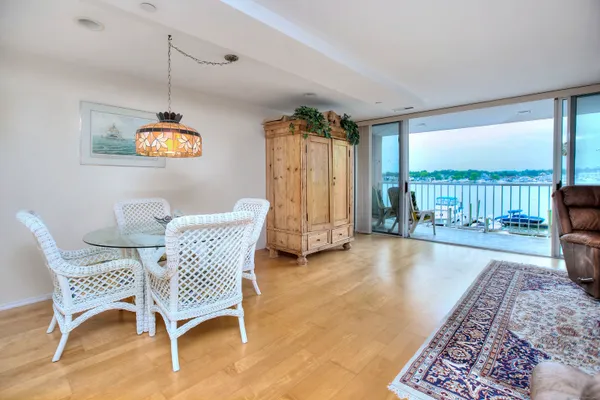 a dining room with furniture and a floor to ceiling window