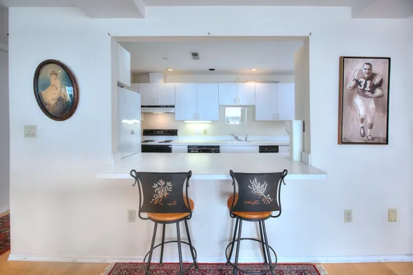 a view of kitchen with cabinets and chandelier