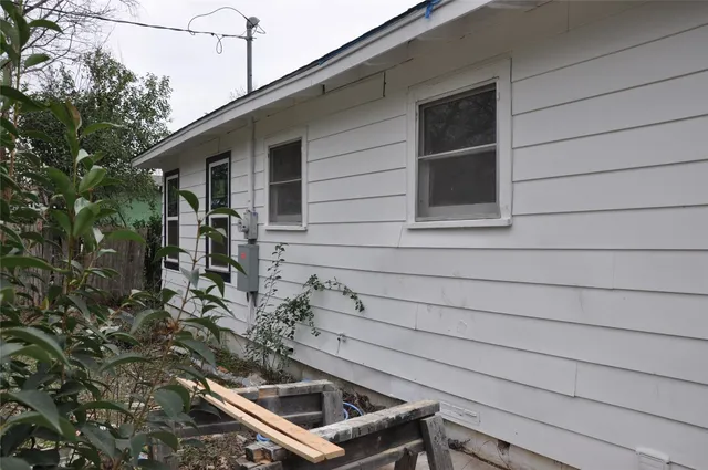 a backyard of a house with table and chairs