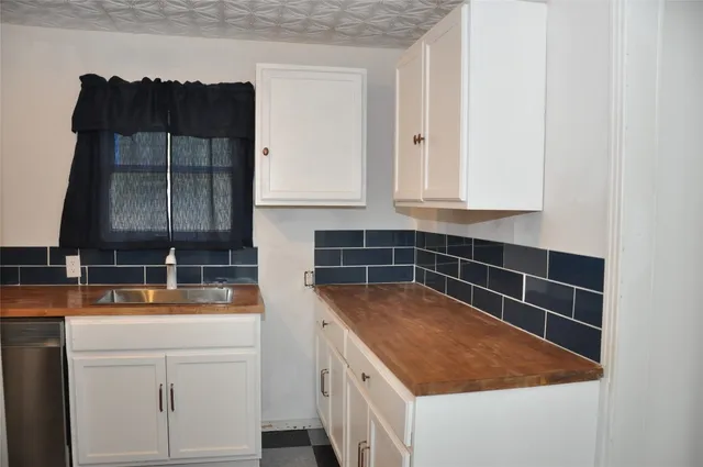 a kitchen with a sink and cabinets