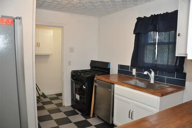 a kitchen with a sink and a refrigerator