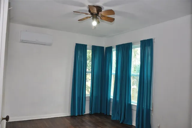 a view of a livingroom with a chandelier fan and closet