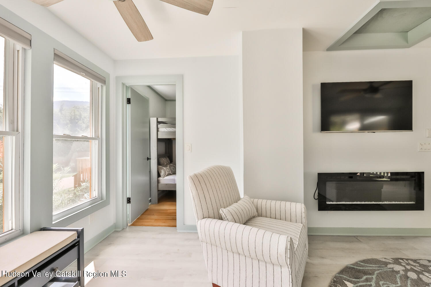10398 Highway 23A Jewett, NY 12442 - Photo 20 of 55 a living room with furniture a flat screen tv and a fireplace