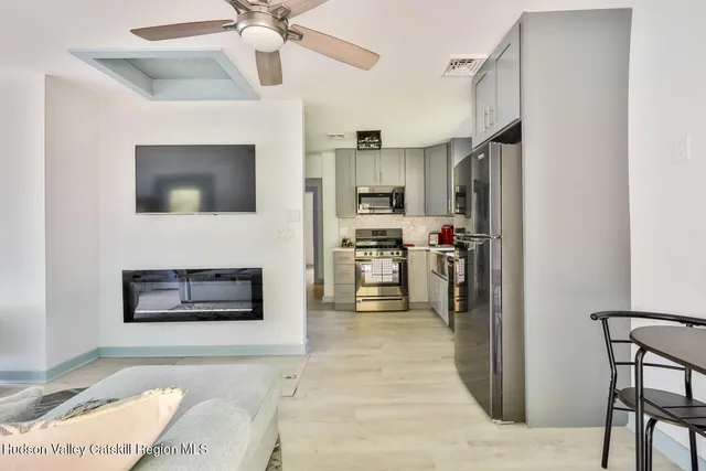 a view of a livingroom with couch and a chair