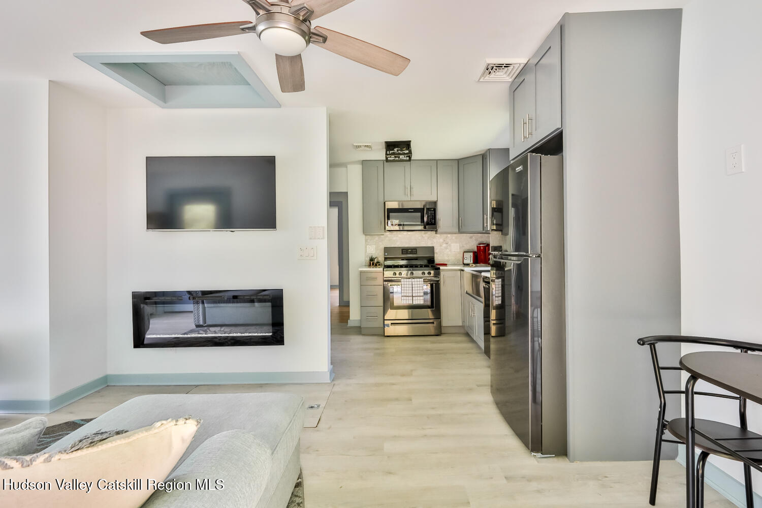 10398 Highway 23A Jewett, NY 12442 - Photo 24 of 55 a living room with stainless steel appliances furniture a fireplace and a flat screen tv