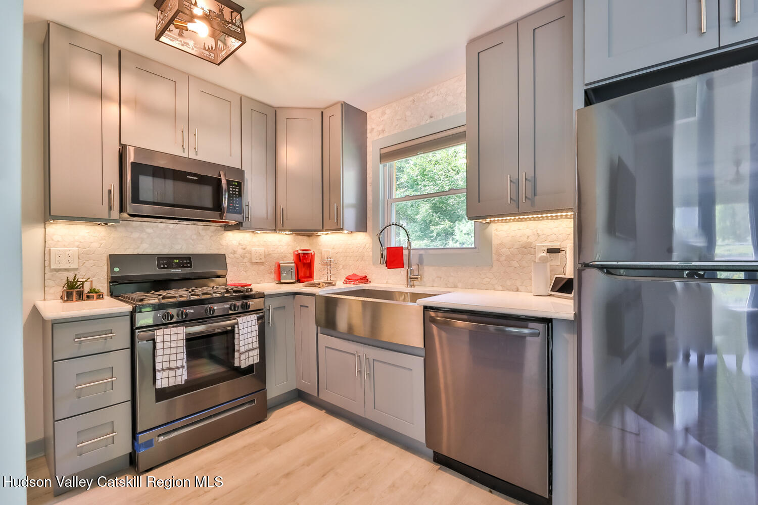 10398 Highway 23A Jewett, NY 12442 - Photo 3 of 55 a kitchen with stainless steel appliances granite countertop a stove a sink and a microwave
