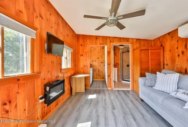 a front view of a house with a yard and potted plants