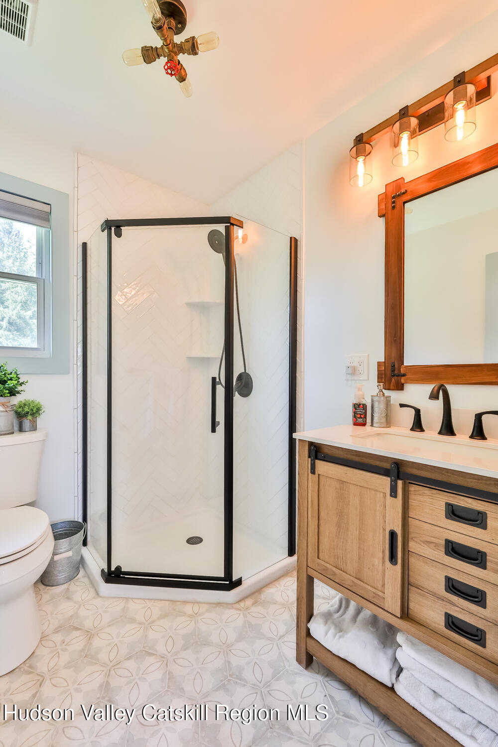 10398 Highway 23A Jewett, NY 12442 - Photo 5 of 55 a bathroom with a sink mirror vanity and toilet