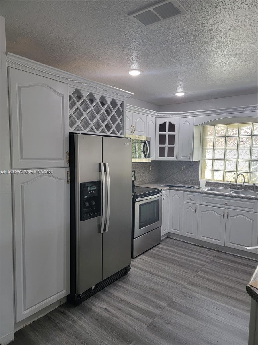 3333 Southwest 156th Court Miami, FL 33185 - Photo 11 of 33 a kitchen with a refrigerator and a sink