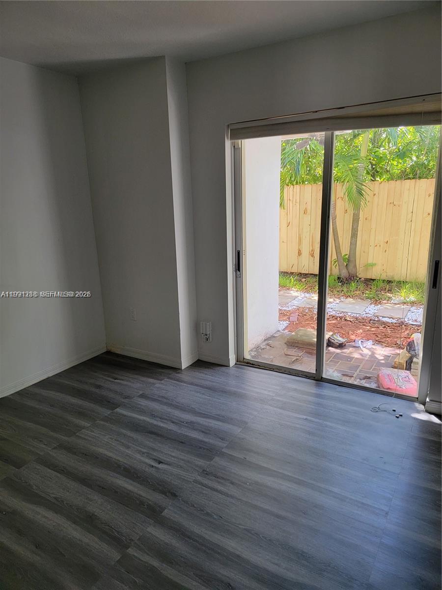 3333 Southwest 156th Court Miami, FL 33185 - Photo 13 of 33 a view of an empty room with wooden floor and a window