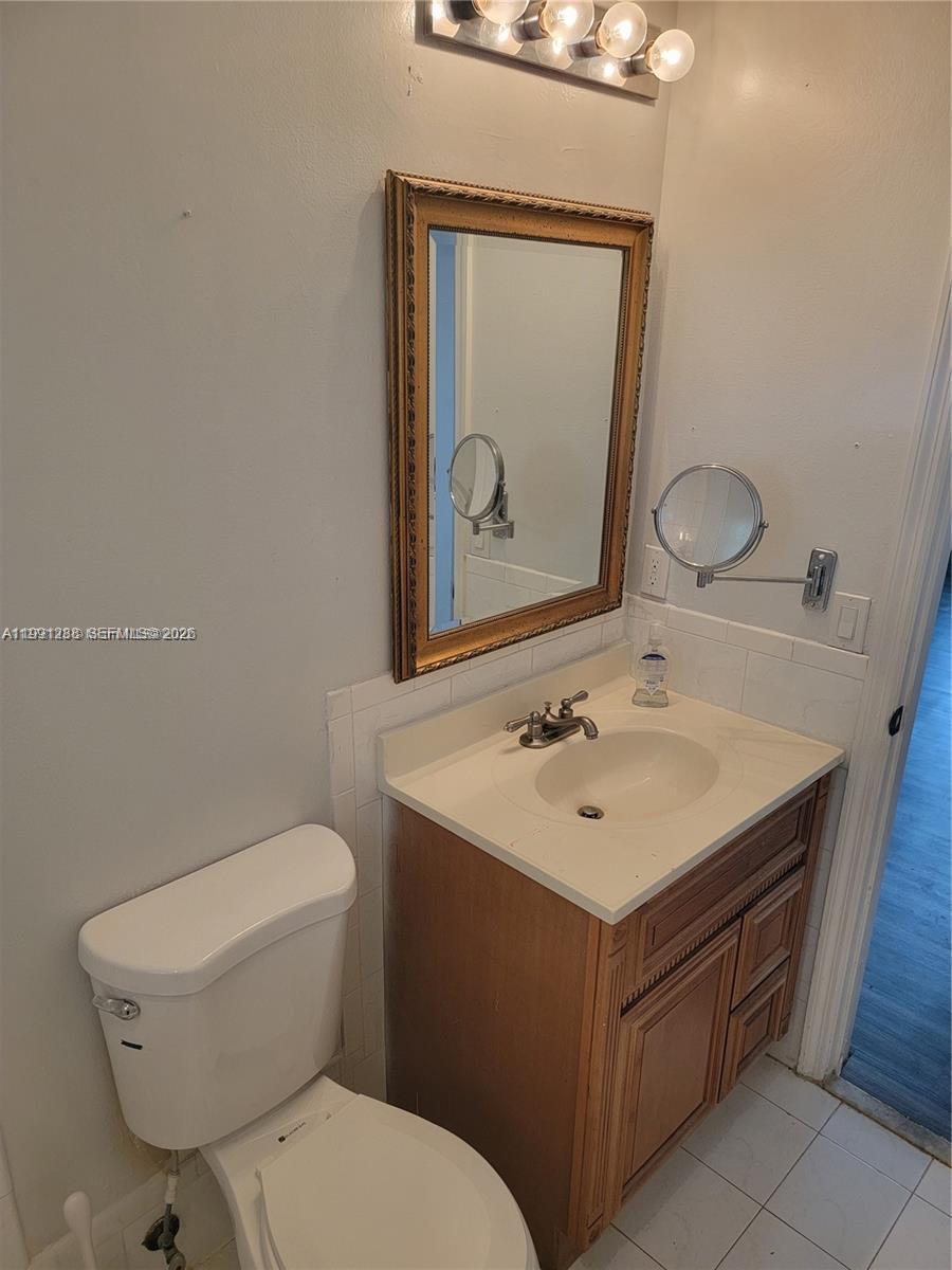 3333 Southwest 156th Court Miami, FL 33185 - Photo 15 of 33 a bathroom with a toilet sink and mirror
