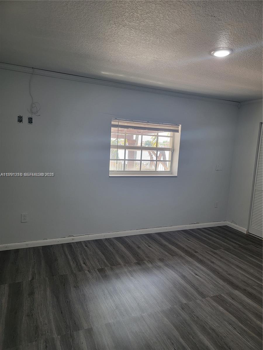 3333 Southwest 156th Court Miami, FL 33185 - Photo 16 of 33 an empty room with wooden floor and windows