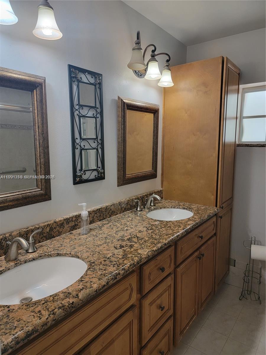 3333 Southwest 156th Court Miami, FL 33185 - Photo 18 of 33 a bathroom with a granite countertop double vanity sink and a mirror
