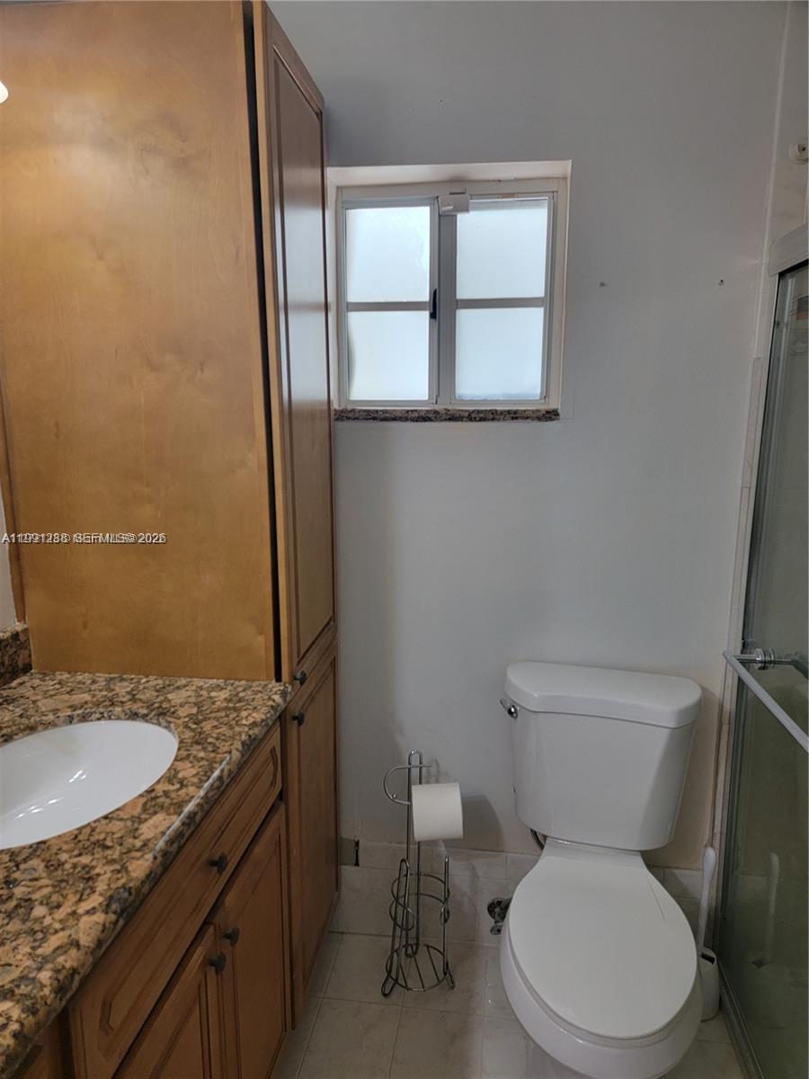 3333 Southwest 156th Court Miami, FL 33185 - Photo 19 of 33 a white toilet sitting next to a bathroom sink