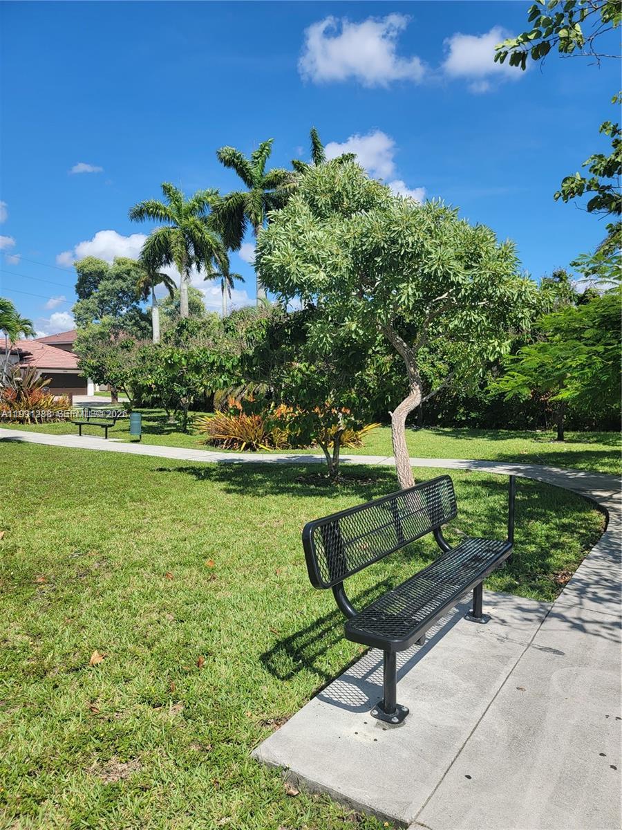 3333 Southwest 156th Court Miami, FL 33185 - Photo 28 of 33 a view of a bench in the garden near a lake