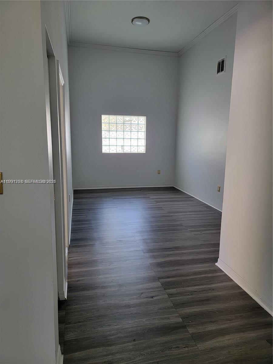 3333 Southwest 156th Court Miami, FL 33185 - Photo 5 of 33 a view of an empty room with wooden floor and a window