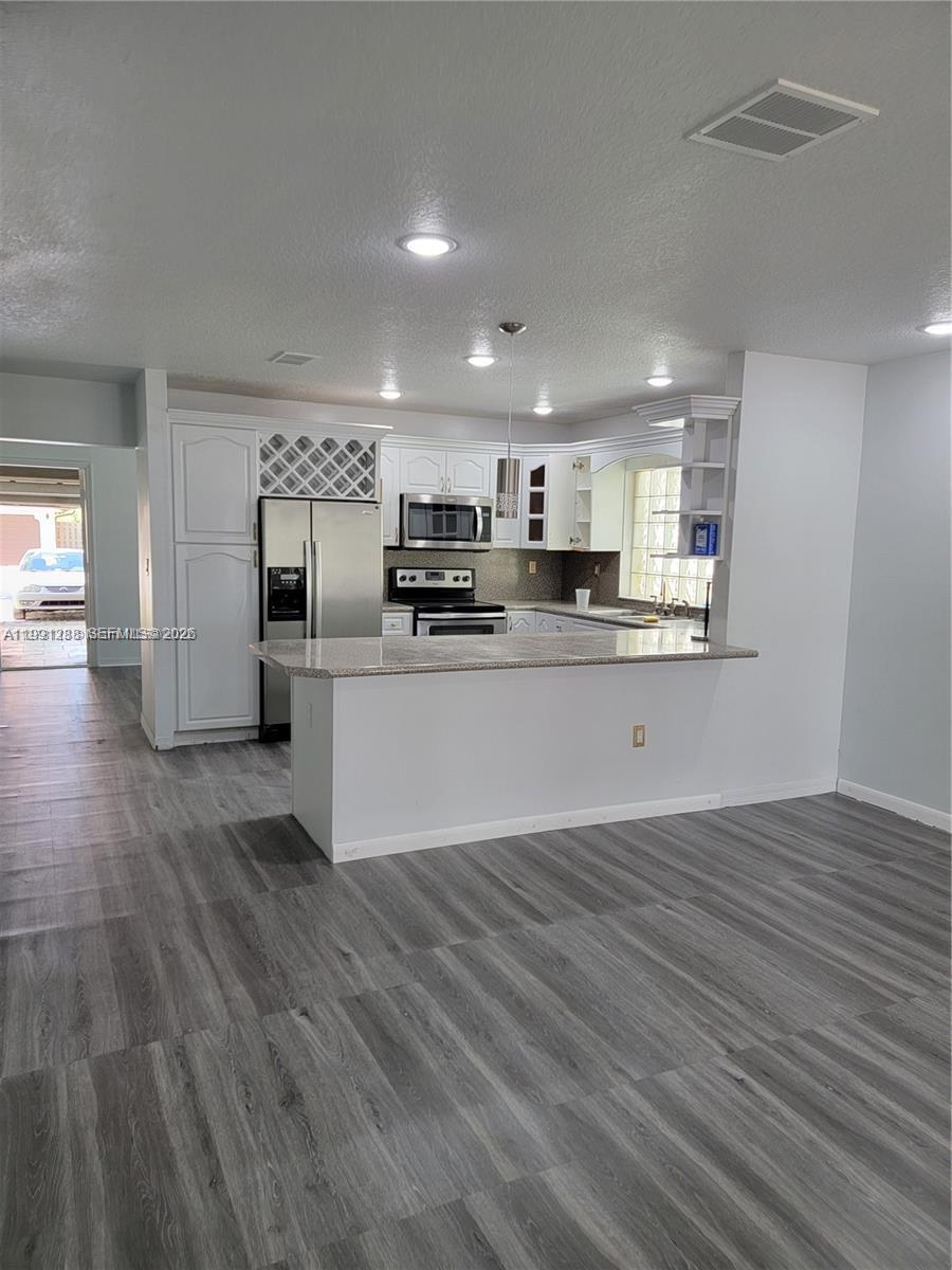 3333 Southwest 156th Court Miami, FL 33185 - Photo 8 of 33 a kitchen with stainless steel appliances a refrigerator and a stove top oven