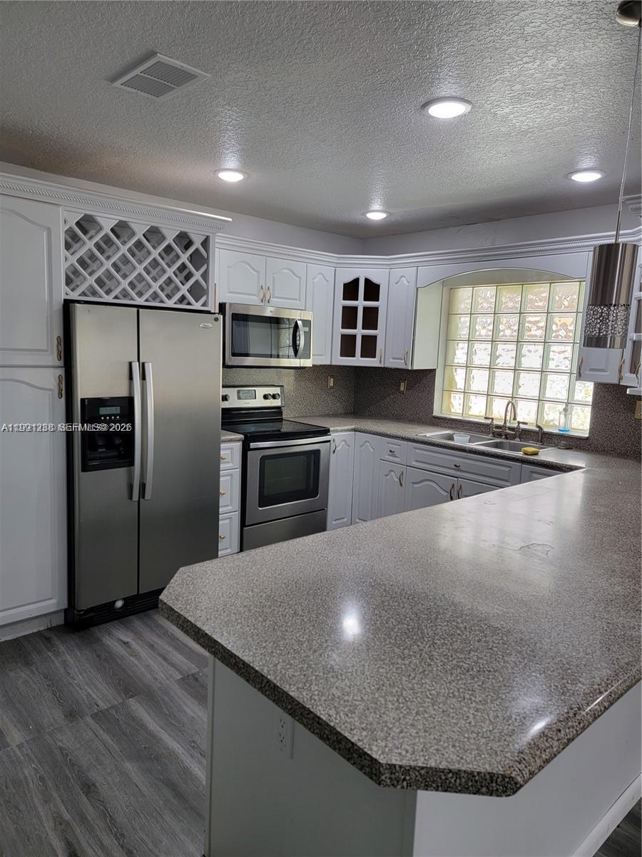 3333 Southwest 156th Court Miami, FL 33185 - Photo 10 of 33 a kitchen with kitchen island a sink stainless steel appliances and window