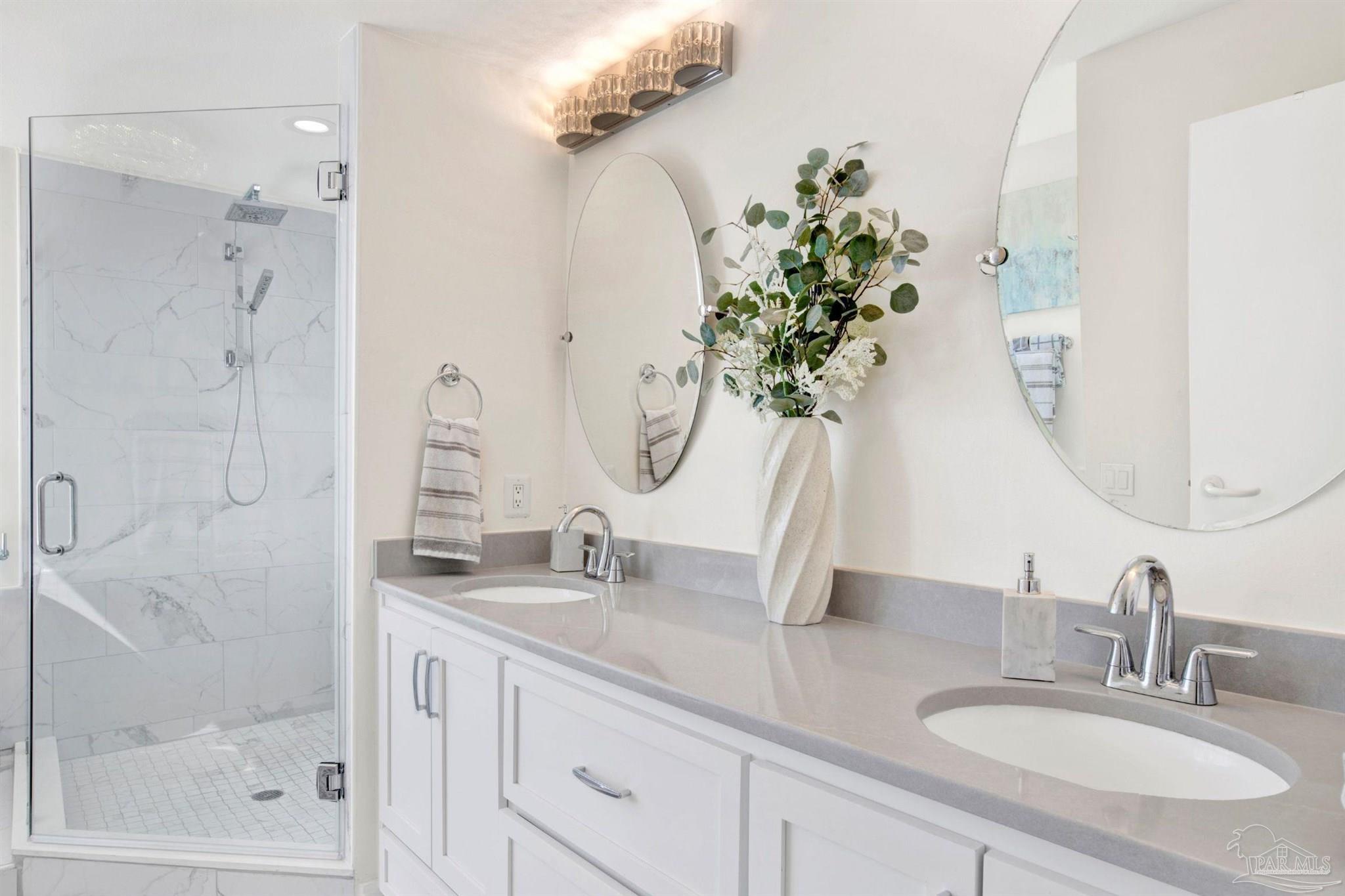 13601 Perdido Key Drive, Unit W10B Pensacola, FL 32507 - Photo 14 of 25 a bathroom with a granite countertop sink a potted plant and a shower