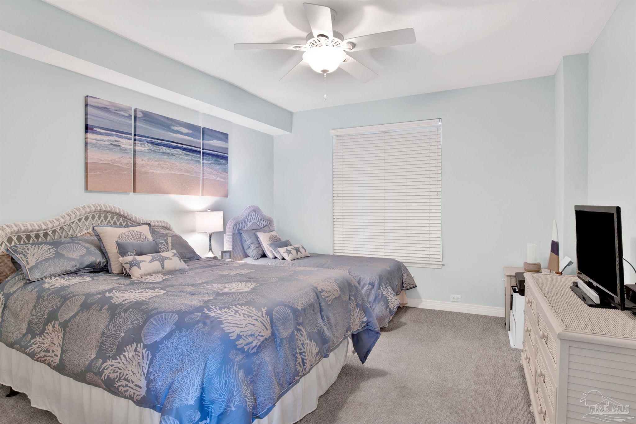 13601 Perdido Key Drive, Unit W10B Pensacola, FL 32507 - Photo 15 of 25 a bedroom with a bed and a flat screen tv
