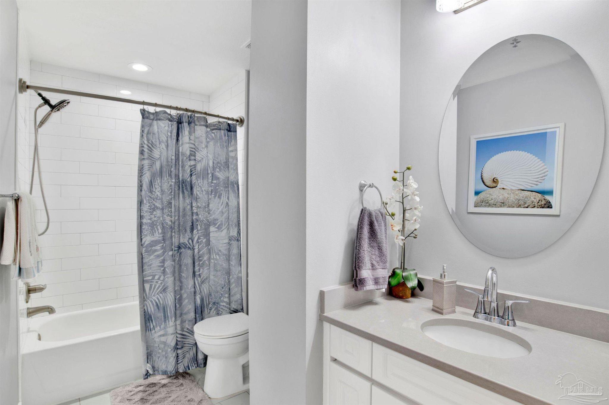 13601 Perdido Key Drive, Unit W10B Pensacola, FL 32507 - Photo 16 of 25 a bathroom with a granite countertop sink toilet and shower