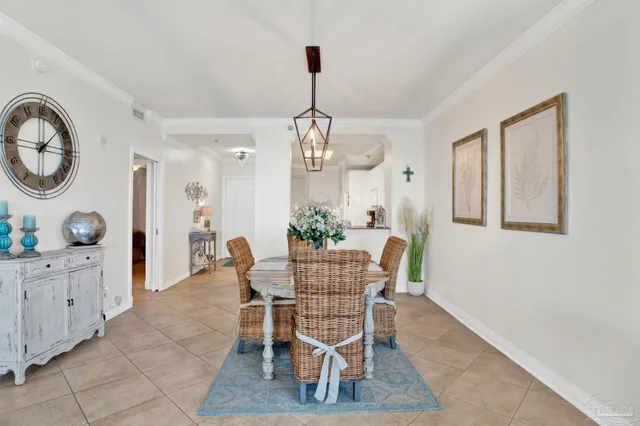 a dining room with furniture a chandelier and wooden floor