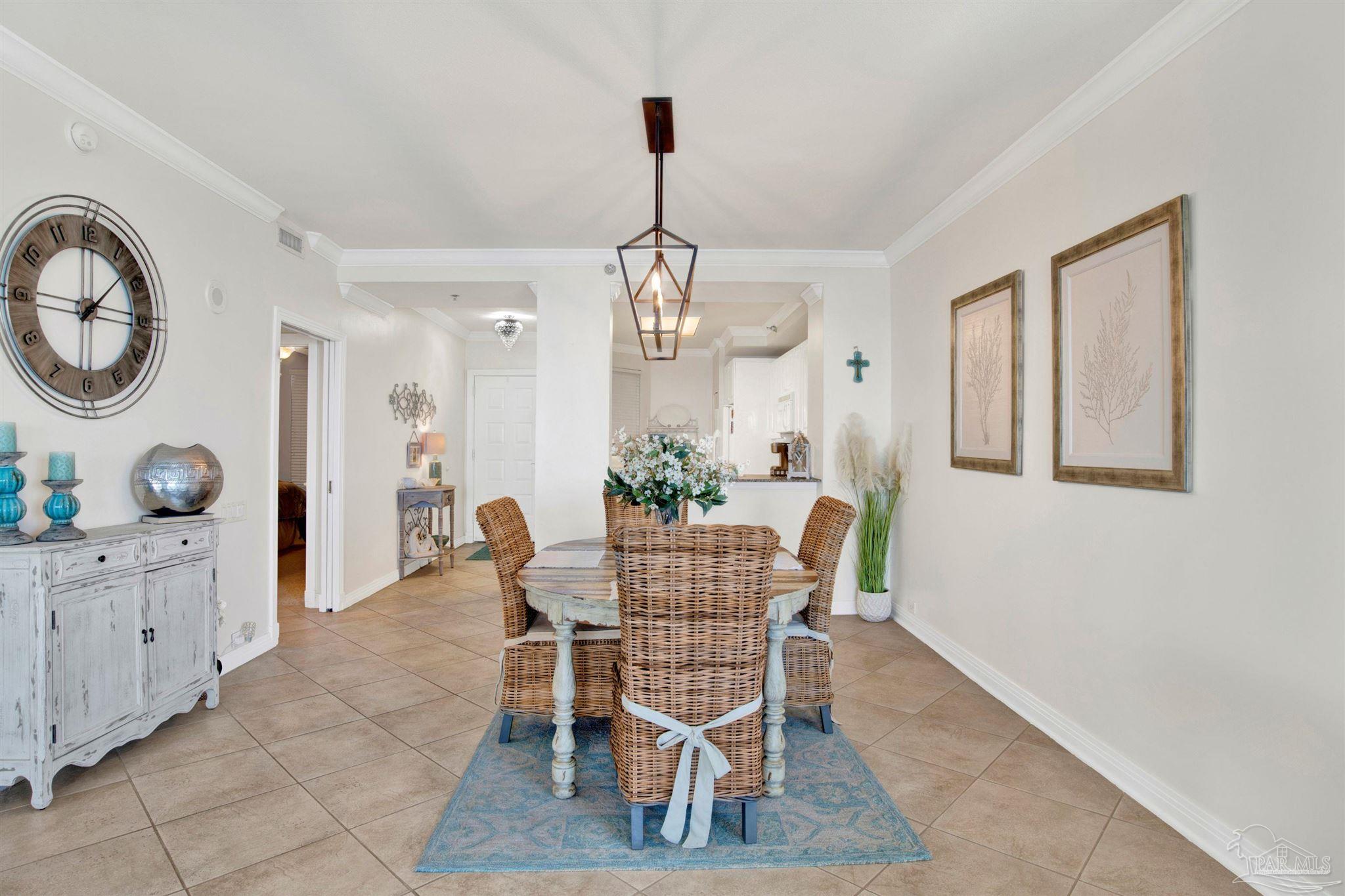 13601 Perdido Key Drive, Unit W10B Pensacola, FL 32507 - Photo 7 of 25 a dining room with furniture a chandelier and wooden floor