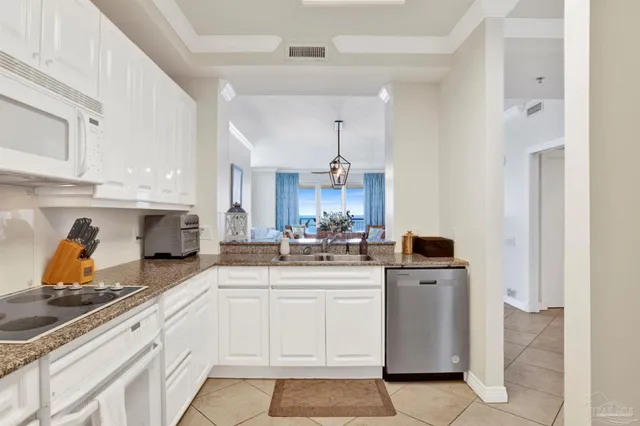 a kitchen with stainless steel appliances a sink stove and cabinets
