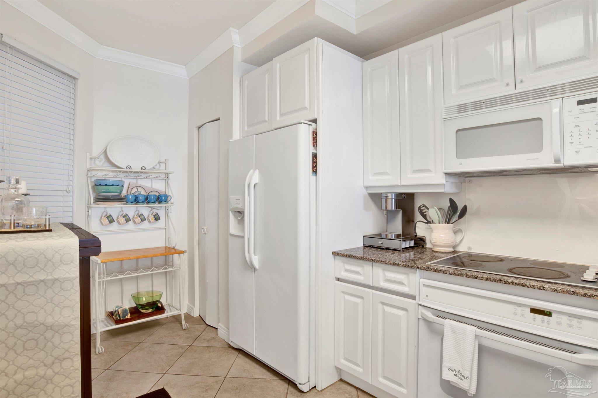 13601 Perdido Key Drive, Unit W10B Pensacola, FL 32507 - Photo 10 of 25 a kitchen with stainless steel appliances granite countertop a refrigerator and a stove