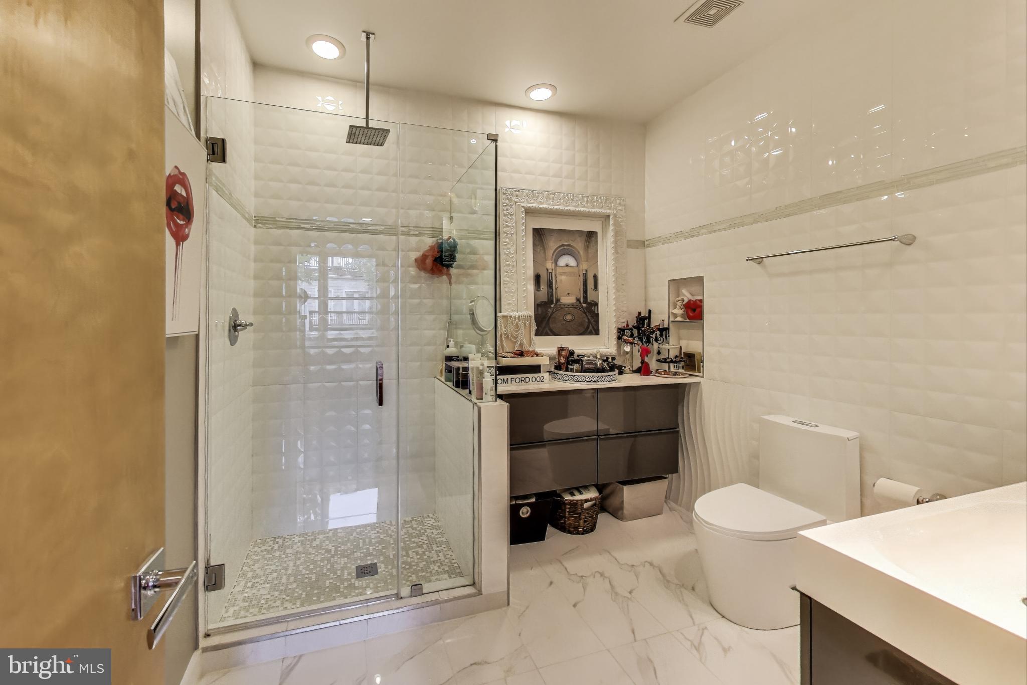 1242 New Jersey Avenue Northwest Washington, DC 20001 - Photo 14 of 60 a bathroom with a sink a toilet a mirror and shower